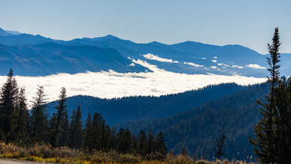 Mist and sunlight weave together over Wyoming&rsquo;s mountains in a serene dawn embrace.