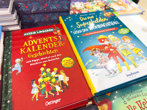 Villach, Austria - November 10, 2025: Advent calendar stories by Astrid Lindgren and superhero tales for Christmas, showcasing colorful book covers in a festive display with vibrant illustrations
