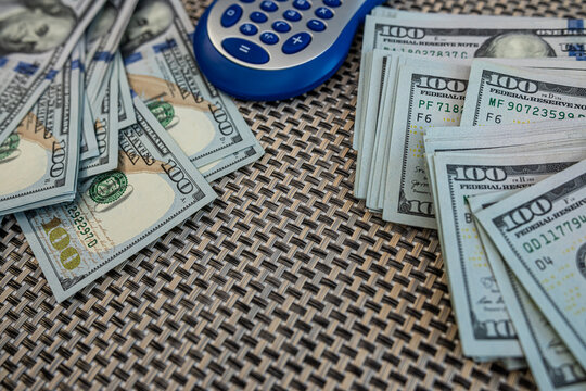 Office calculator on US currency symbolizing business finance, income management and profit analysis