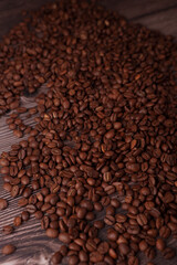 abundant coffee beans spread across a rustic wooden surface, showcasing rich, deep browns and inviting texture, evoking warmth, aroma, and a sense of comforting indulgence, neutral, unprocessed