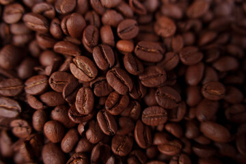 close-up view of a heaping pile of rich brown coffee beans with detailed surface texture and dark mahogany hues showcasing the vibrant appeal of freshly roasted coffee, gourmet, luxury, earthy