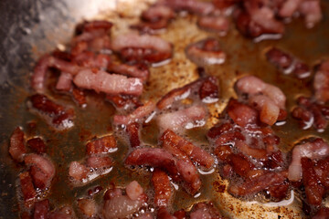 close-up of sizzling bacon strips releasing flavorful oils and juices in a hot frying pan, showcasing the rich browns and pinks of the meat amidst glistening bubbles and golden hues, cooked, glazed