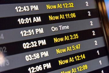 An airline schedule digital display showing delayed and cancelled flights