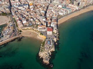 Aerial view of Benidorm, Spain, showcasing high-rise buildings and the Mediterranean Sea in the background.