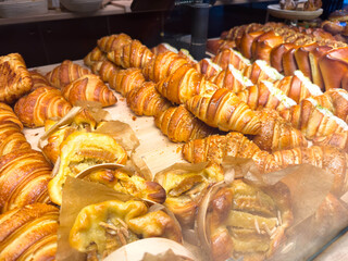 Display of freshly baked pastries with croissants and danish pastries in a bakery