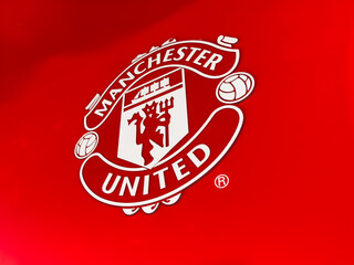 Obraz premium Manchester United crest logo on red background, iconic football club emblem for Manchester, UK
