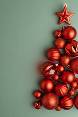 Green and Gold Christmas Ornaments Hanging on Pine Branches over Muted Green Background