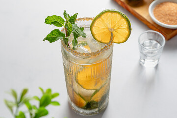 45 degree angle View of a backlit Refreshing Mandarin Lime Spearmint Mojito