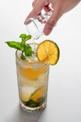 Frozen Moment of White Rum Pouring into Mandarin Lime Mojito