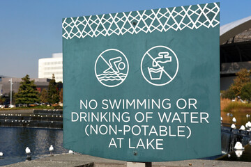 Warning Sign by the Lake “No Swimming or Drinking of Water (Not Potable)