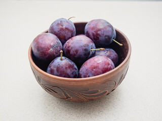 fresh plums in a bowl