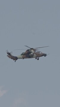Vertical footage of a military helicopter performing combat flight maneuvers