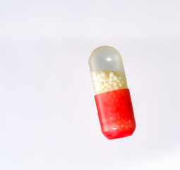 Red and White Medical Capsule with Granules Inside