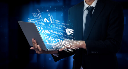 A business professional showcases technology trends using a laptop. The image highlights topics...
