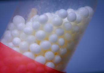 Red and White Medical Capsule with Granules Inside