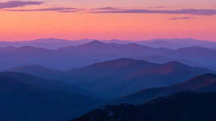 Fototapeta premium Mountain ranges revealing vibrant colors during sunset, creating a serene, layered atmospheric landscape at dusk
