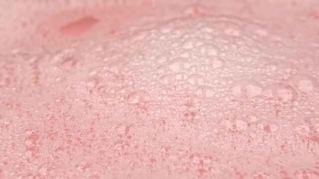 white soapy water on a pink background