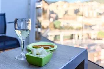 Glass of white wine cafe and fruit light snack on table in sunlight. Atmosphere of delightful event and romantic summer. High quality photo