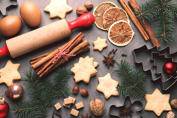 Merry Christmas and Happy Holidays greeting card with cookies, spices and fir tree branches