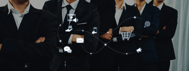 A confident business team stands together, showcasing a blend of professionalism and modern technology with digital icons symbolizing communication and marketing strategies. Trope