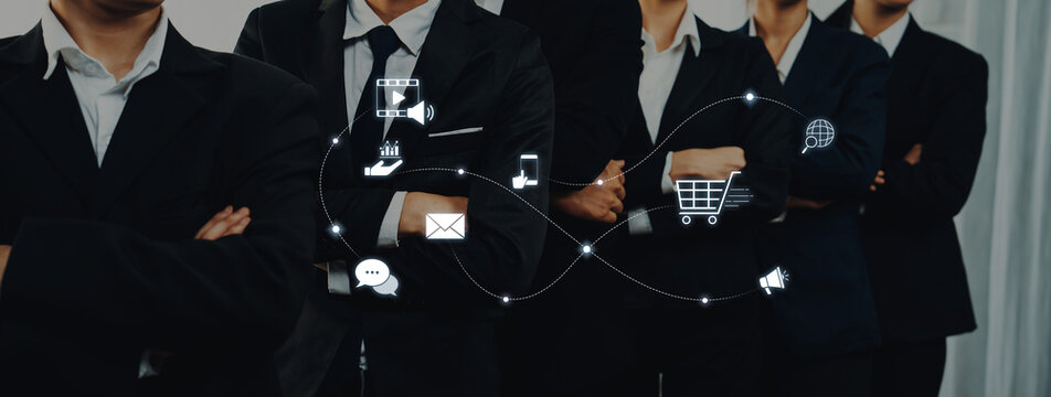 A confident business team stands together, showcasing a blend of professionalism and modern technology with digital icons symbolizing communication and marketing strategies. Trope