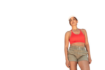 Young woman standing in casual athletic wear looking confidently up on white background