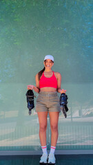 Happy woman holding rollerblades, ready for an outdoor activity