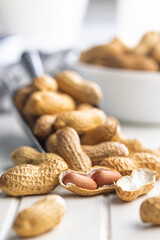 Peanuts in shell. Groundnuts on white table.