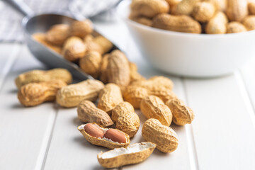 Peanuts in shell. Groundnuts on white table.