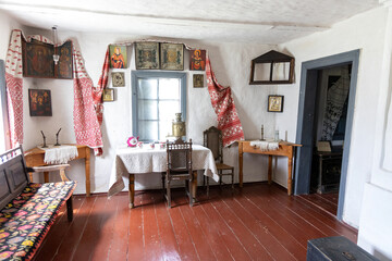 Traditional Eastern European rural house interior with icons and vintage furniture