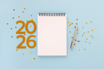 New Year 2026 planning concept with notebook and golden numbers for your goals, plans, resolutions. Flat lay style. Christmas planning concept with space for text