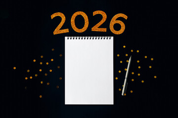 2026 New Year concept with empty notebook for your goals, plans, resolutions. Flat lay style. Christmas planning concept with space for text