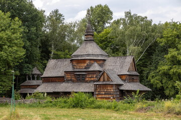 Obraz premium Old wooden church surrounded by lush green trees
