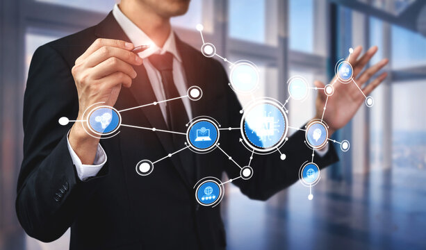 A businessman showcases a digital interface with network connections and icons, symbolizing technology and innovation in a modern business environment. Tessel