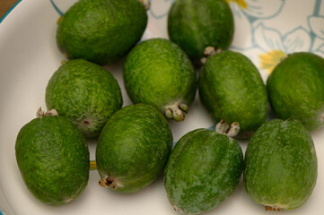 Ripe Feijoas in a White Ceramic Bowl Close-Up