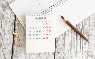December, 10 on calendar on wooden table close up.
