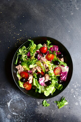 Tuna salad with fresh vegetables. Top view with copy space.