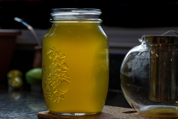 Mason jar with just steeped  green tea during early morning in kitchen