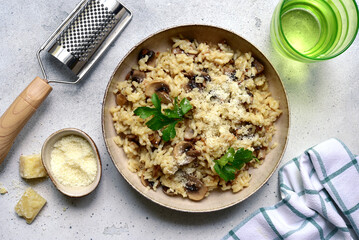 Risotto with mushrooms - tradishional dish of italian cuisine. Top view with copy space.