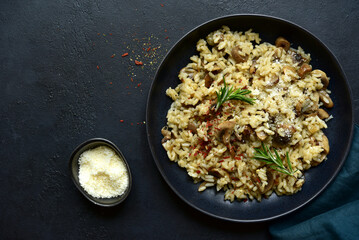 Risotto with mushrooms - tradishional dish of italian cuisine. Top view with copy space.