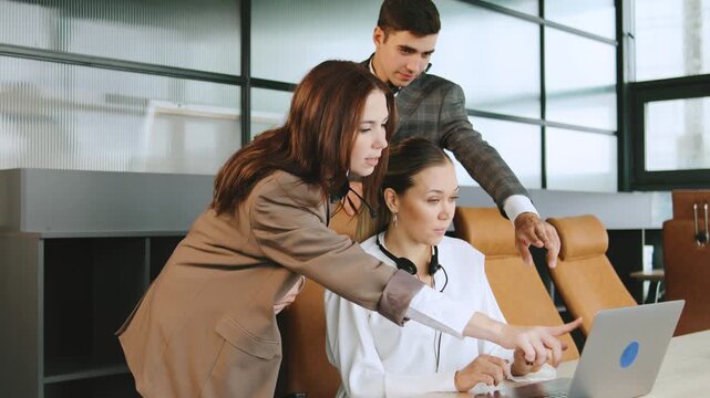 Close-up of business consultants in a modern office setting providing technical support to clients using computers and headphones