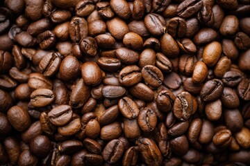 Fototapeta premium Lots of coffee beans top-down view photography. Coffee roasting industry and beverage concept.