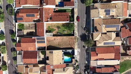 Aerial view of houses with red roofs and a road - Powered by Adobe