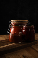 Homemade canned salsa and relish on wooden board