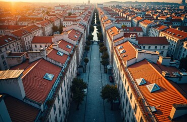 Aerial view of a European city street lined with colorful buildings and red rooftops at sunset