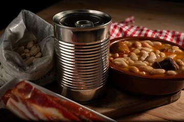 Preparing traditional spanish fabada stew with canned beans and ingredients