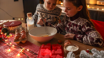 Children baking together in a cozy kitchen during the holiday season
