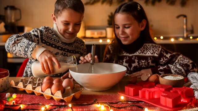 Children baking together in a cozy kitchen during the holiday season
