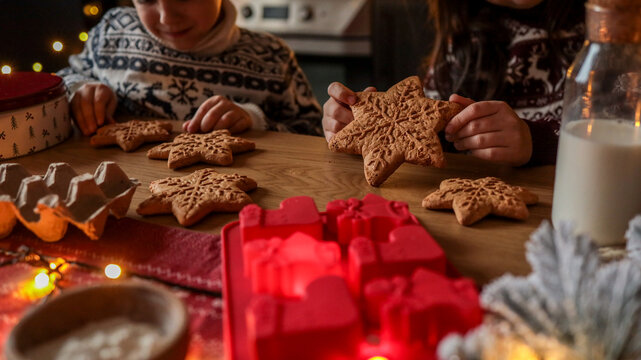 Children baking and decorating Christmas star-shaped gingerbread cookies - Powered by Adobe
