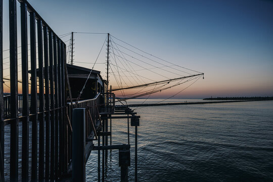 Trabocco fishing structure on Adriatic Sea at sunset.